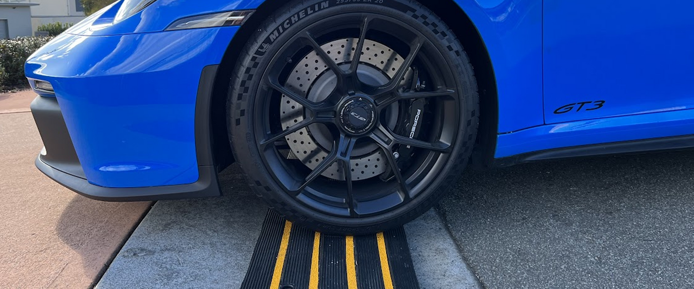 Blue car going over a Ramp Champ driveway ramp