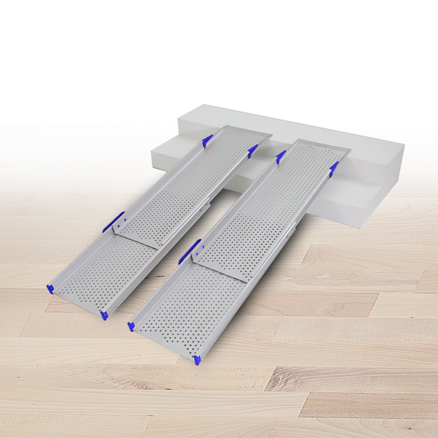 A pair of Heeve Aluminium Telescopic Mobility Ramps with perforated surfaces extended over a small set of steps, showcasing their anti-slip design and orange securing brackets for safe and stable placement