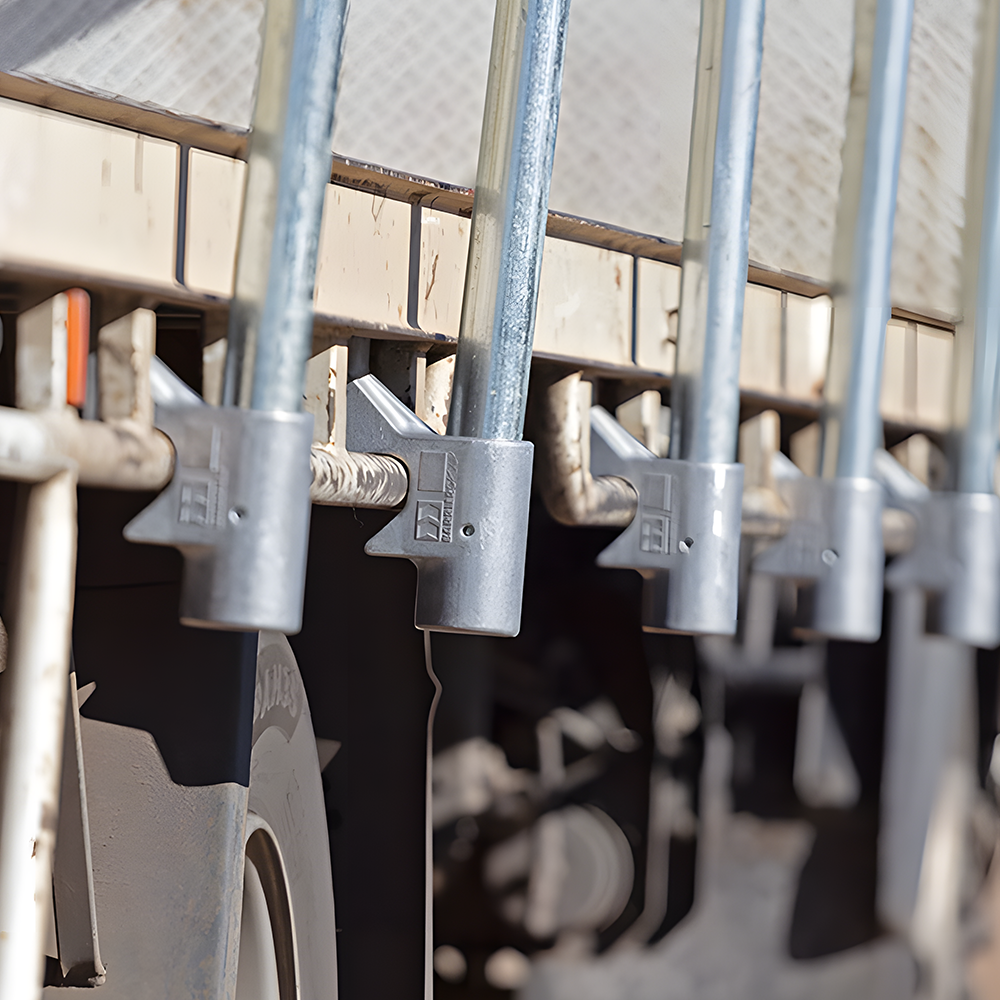 Close-up of the end of an orange guardrail, featuring "Barrier Group" branding.