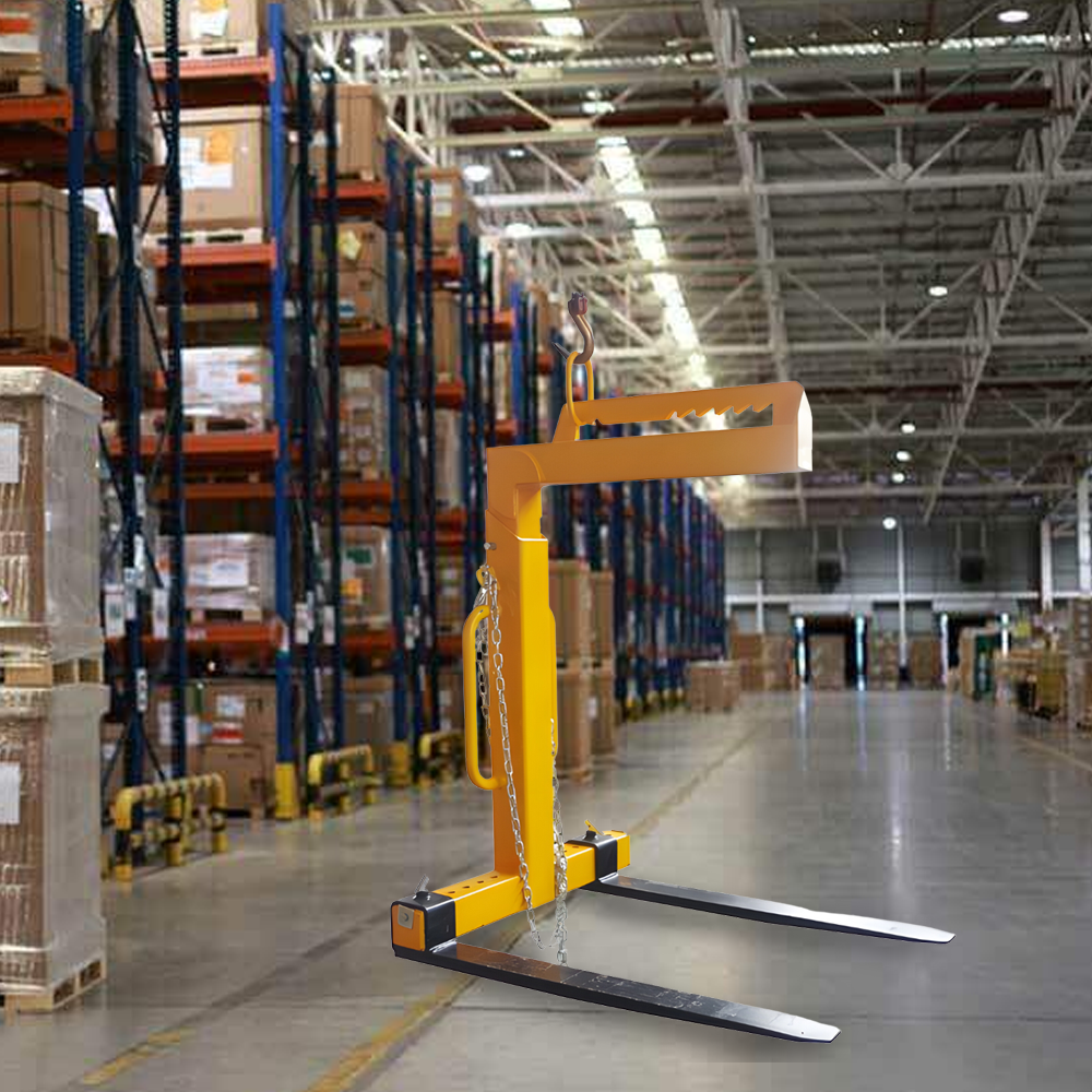 The yellow crane pallet lifter attachment positioned in a warehouse aisle, demonstrating its practical use in handling pallets.