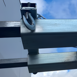 Close-up angle showing the metal hook attached to the side of the bulk bag carrier, illustrating the rugged design