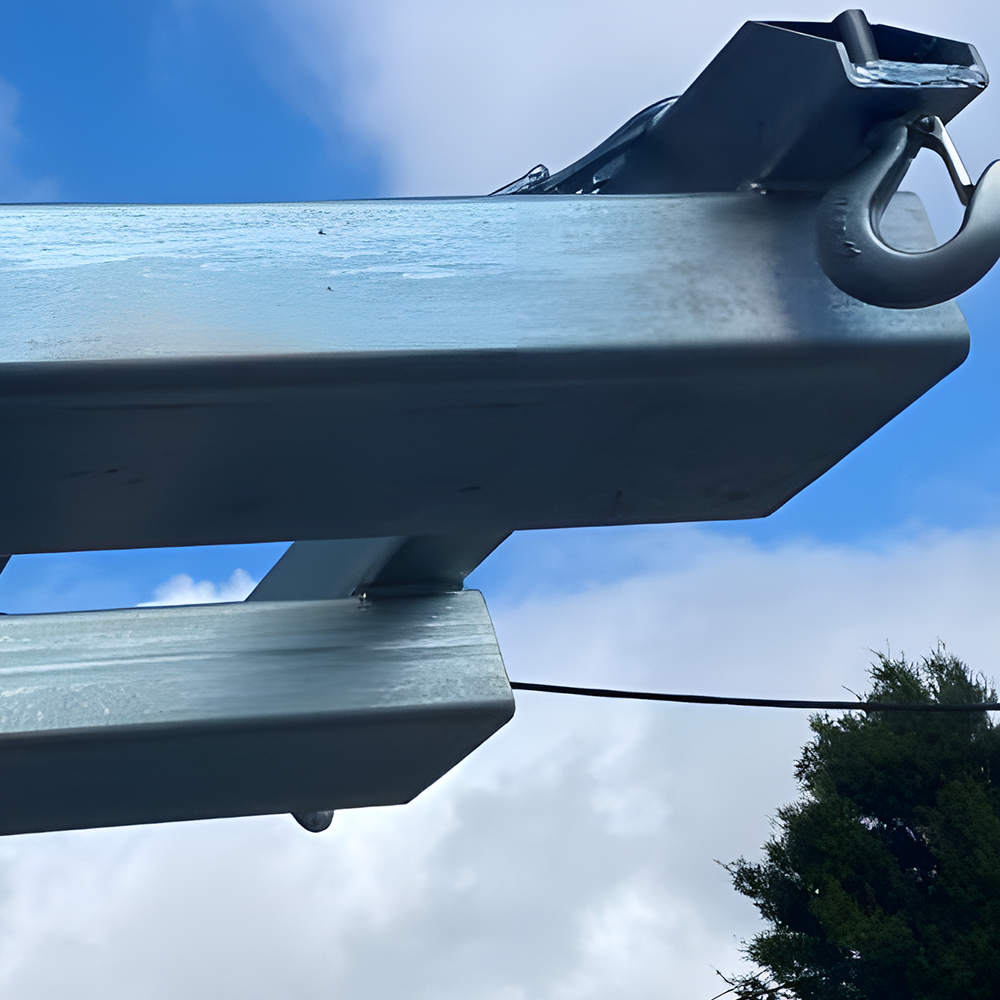 Close-up view of a sturdy metal forklift attachment against a blue sky background, showcasing the durable construction