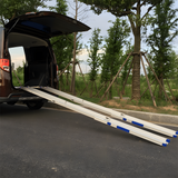 The ramps are extended from the back of a vehicle, providing access to the rear. The blue accents highlight key features.