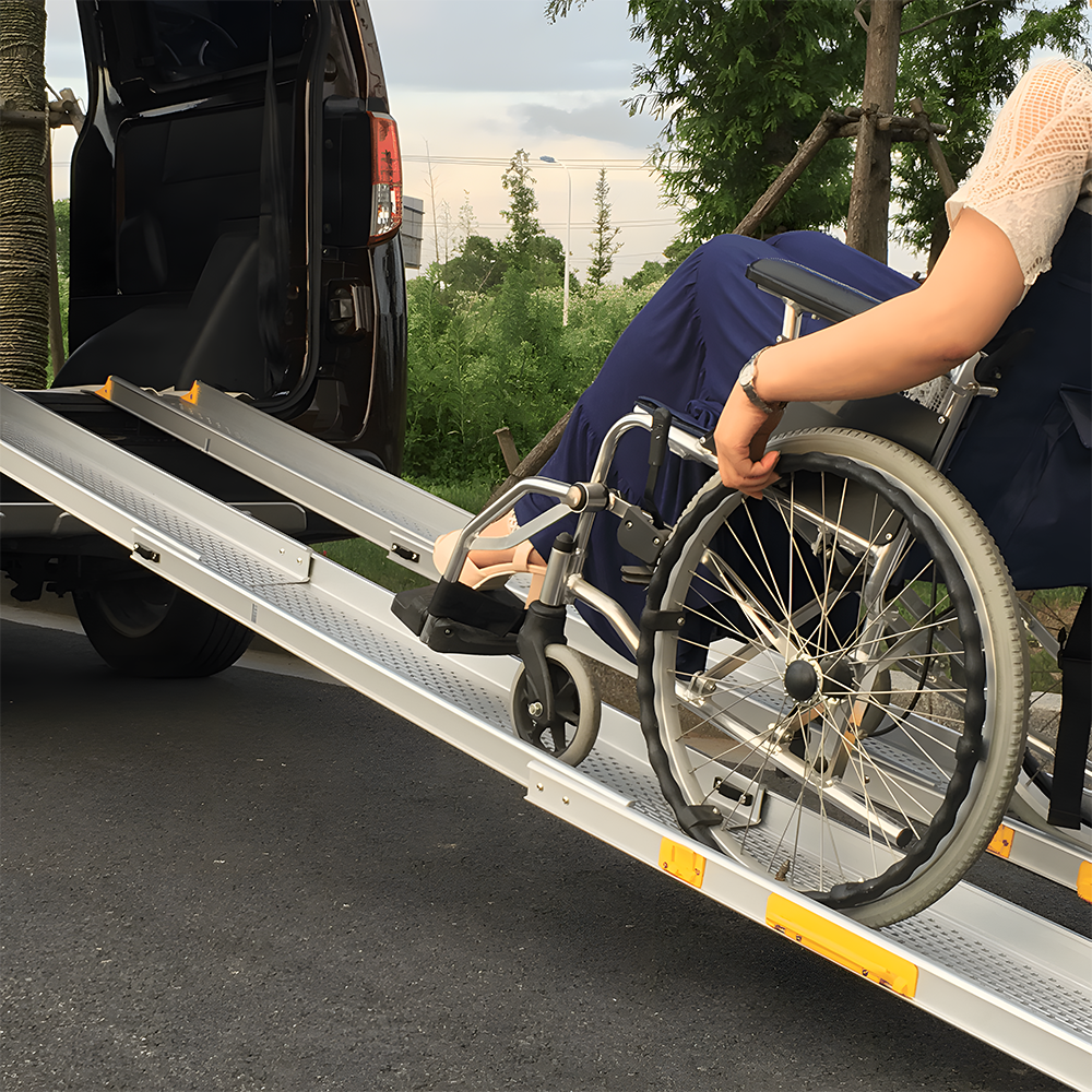 Close-up of a woman in a wheelchair using the Heeve ramp to access a van, highlighting the ramp’s safety and stability