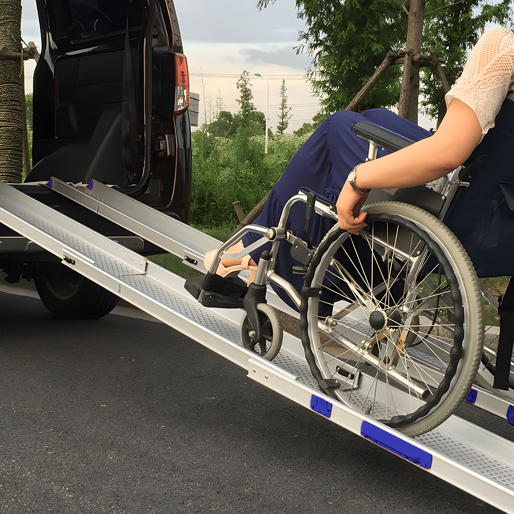 A wheelchair user using the mobility ramps to enter a vehicle. The setup demonstrates the ramps' safety and stability.