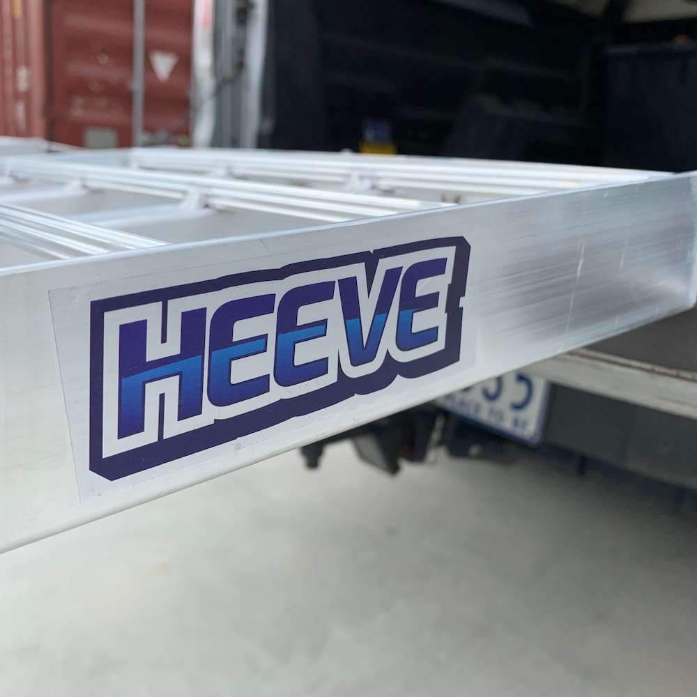 A close-up of the Heeve branding sticker on the side of the aluminium loading ramp, illustrating the product's branding and finish