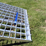 A detailed image showing the aluminium grid structure of the Heeve ramp with a blue safety strap securing it.