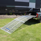 A side view of the Heeve loading ramp attached securely to a truck bed, demonstrating its stable and reinforced build