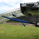 Underside view of the Heeve ramp connected to the truck, showing the blue safety strap firmly attached to prevent movement during use.