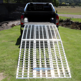 A complete frontal shot of the Heeve aluminium ramp extending from the truck, displaying the wide loading surface suitable for various vehicles and equipment.