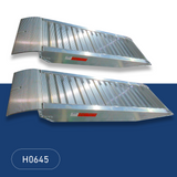 Two Heeve aluminium loading ramps positioned side by side on a blue background, showcasing their durable and sleek design