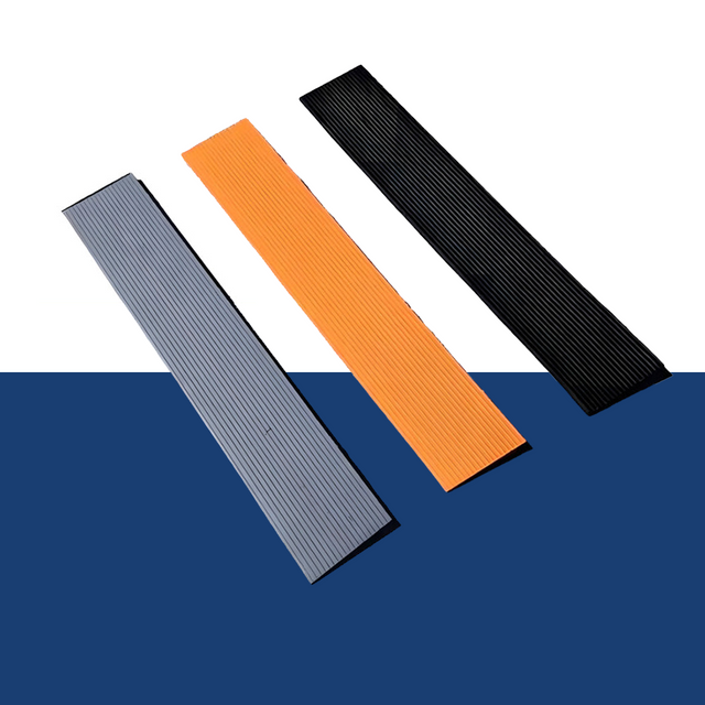 Three Heeve 900mm indoor self-adhesive flexible threshold ramps (grey, orange, black) displayed against a blue background