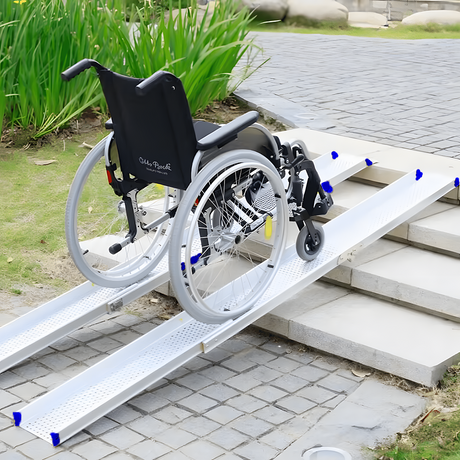 A wheelchair positioned on the Heeve aluminium telescopic ramps, showing secure traction on outdoor steps