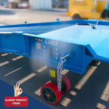 Close-up image of the Heeve Forklift Low Dock Ramp, showcasing its durable steel frame, powder-coated blue finish, and branded Heeve logo. The ramp features red heavy-duty wheels for mobility and a secure safety chain attached to the side. Labelled as 'Almost Perfect Items