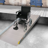 Wheelchair positioned on the Heeve solid non-folding aluminium ramp, ideal for smooth transitions over steps