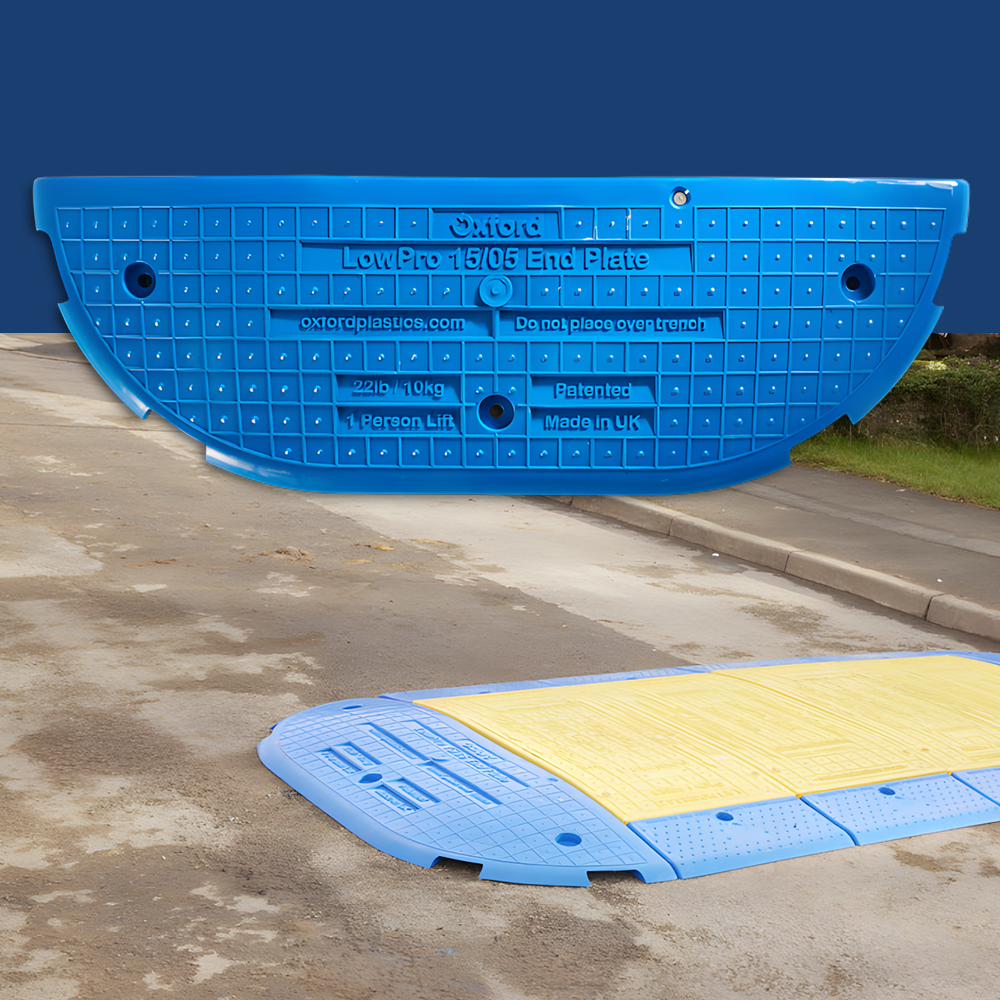 A composite image displaying the blue LowPro 15/05 End Plate in the foreground, with a demonstration of the plate installed in an outdoor urban setting, illustrating its usage over a trench or utility access.