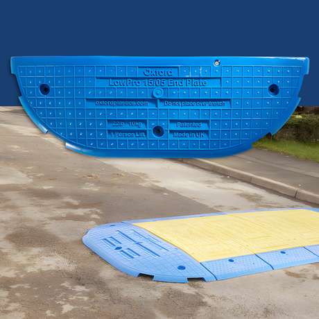 A composite image displaying the blue LowPro 15/05 End Plate in the foreground, with a demonstration of the plate installed in an outdoor urban setting, illustrating its usage over a trench or utility access.