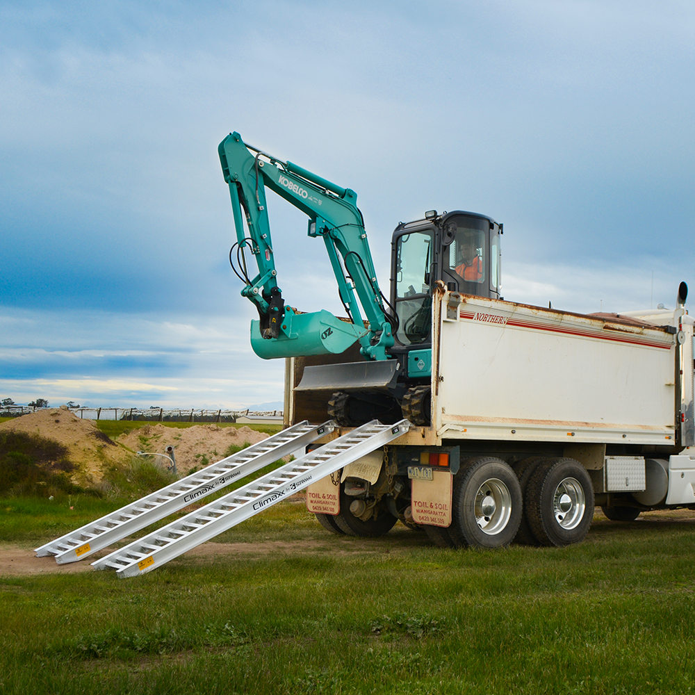 excavator on the ramp and the truck