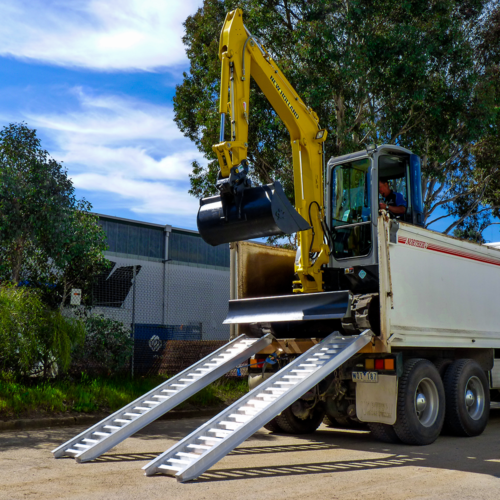 excavator and the ramp attached on the truck