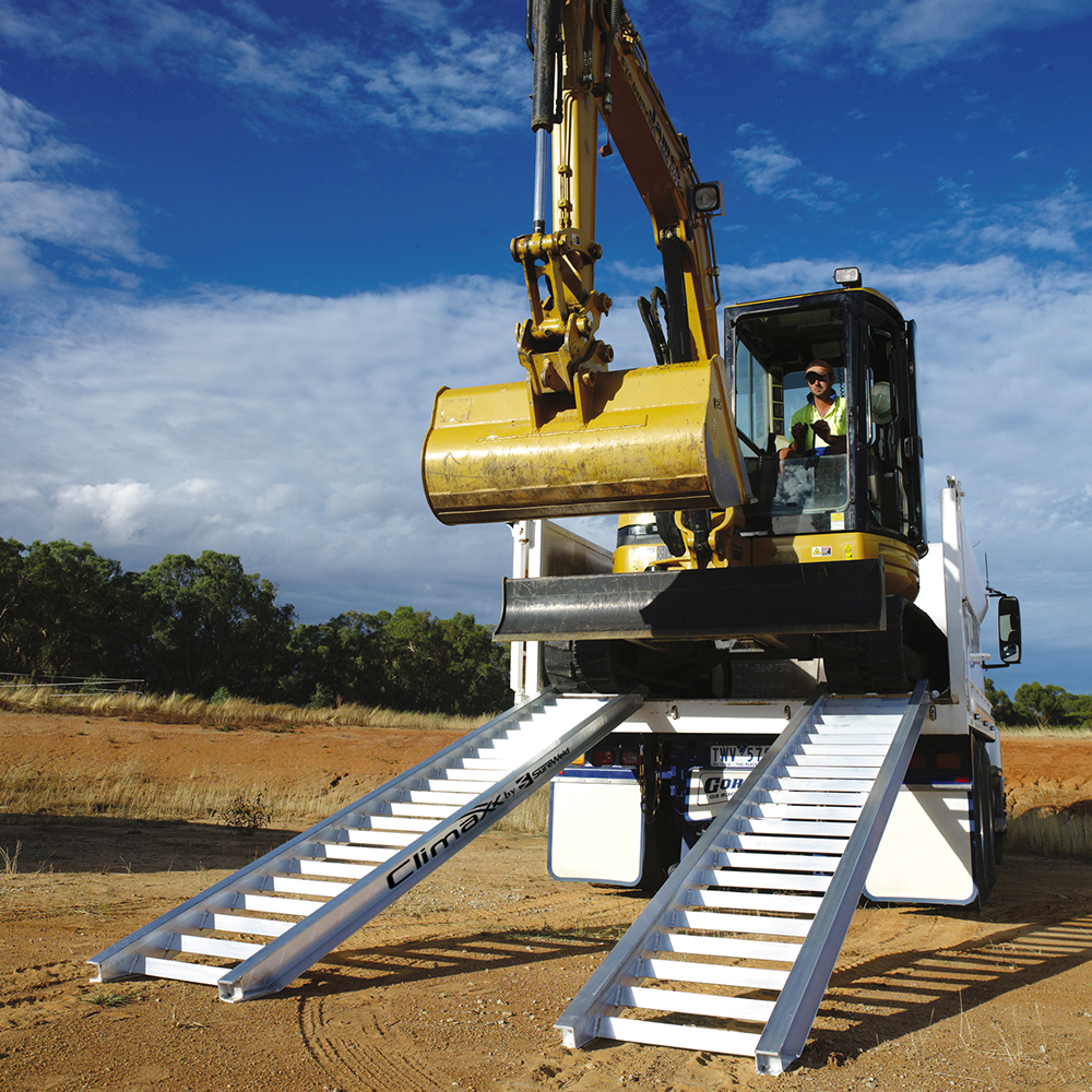 excavator on the truck and ramp