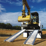 excavator on the truck and ramp