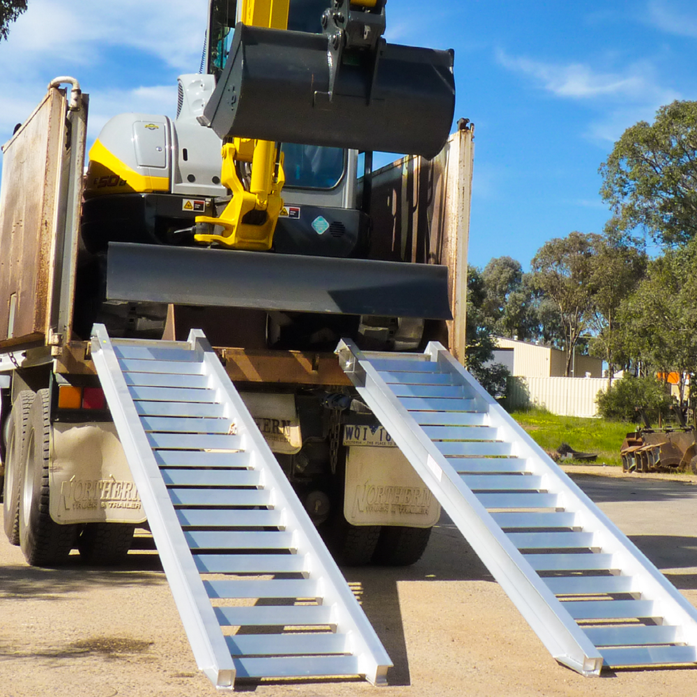 excavator on the rear of the truck descending 