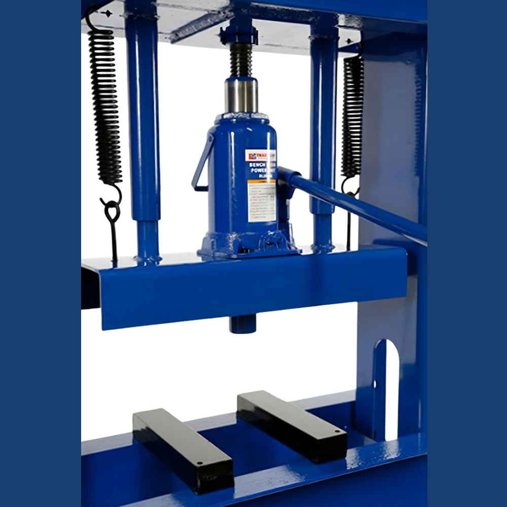 Another angle of the hydraulic press, focusing on the jack assembly and its surroundings. The jack's robust build and the return springs are visible, emphasising its industrial-grade construction.