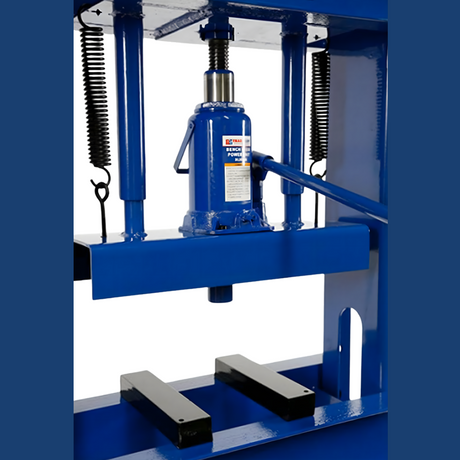 Another angle of the hydraulic press, focusing on the jack assembly and its surroundings. The jack's robust build and the return springs are visible, emphasising its industrial-grade construction.