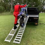 rider moving his motorcycle using Whipps 200kg Non-Folding Aluminium Motorcyle Side-Walk Ramp