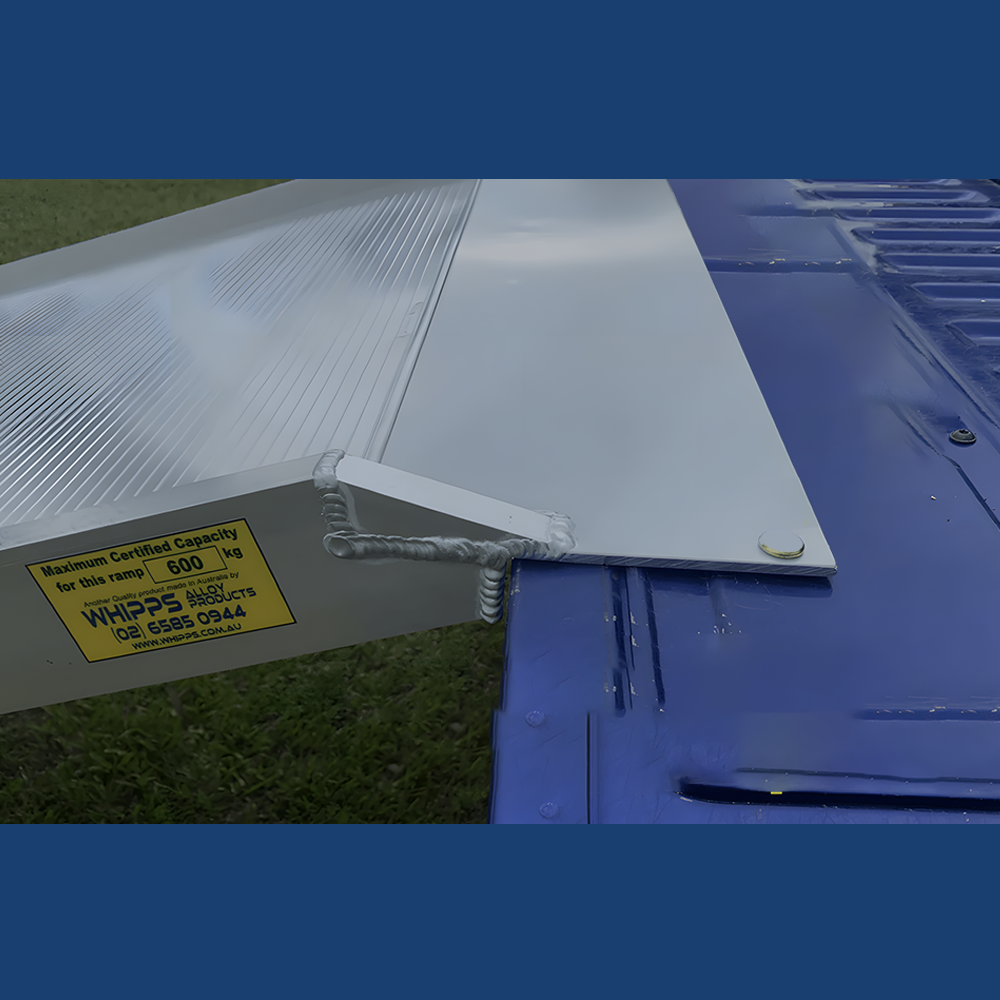 A close-up view of the top of the ramp where it connects to the loading surface, such as a truck bed. This image highlights the ramp's lip with a detailed look at its high-quality welds and the load capacity label indicating a certified capacity of 600kg.