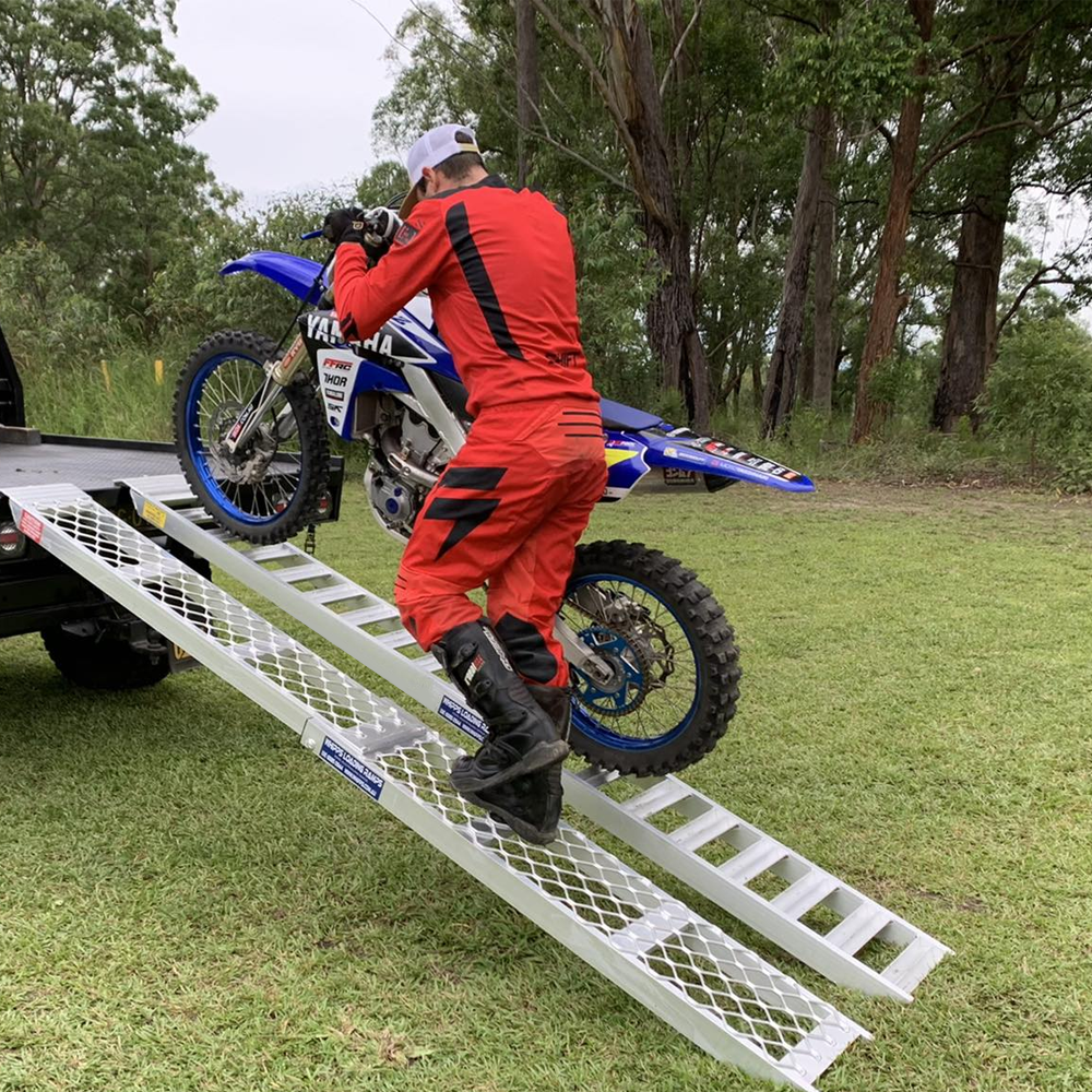 rider moving his motorcycle using Whipps 600kg Non-Folding Aluminium Motorcycle Ramp, Single