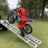 rider moving his motorcycle using Whipps 600kg Non-Folding Aluminium Motorcycle Ramp, Single